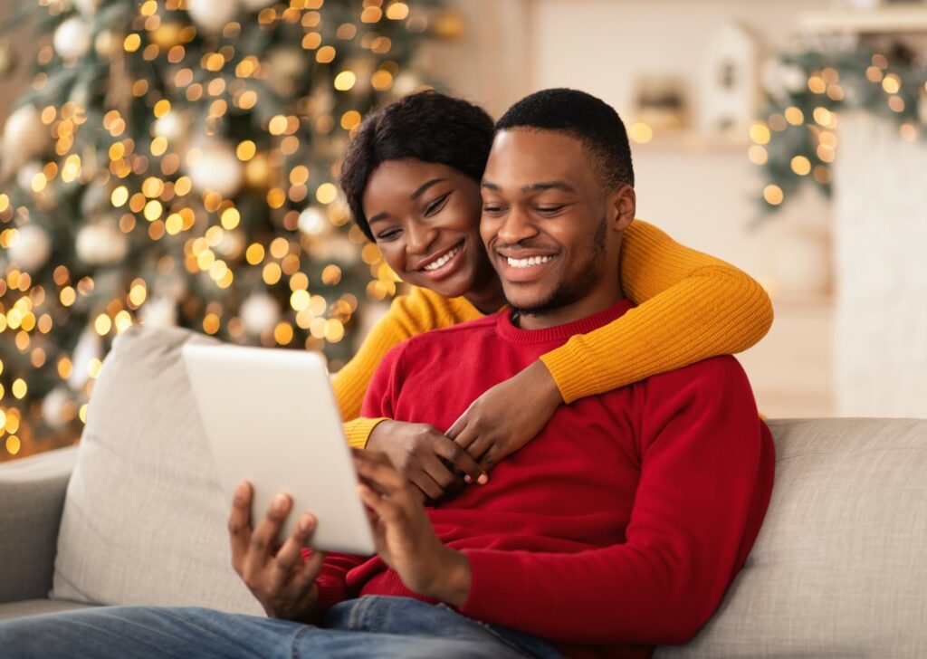 Young couple looking at their new home on the 149Photos website on their tablet.